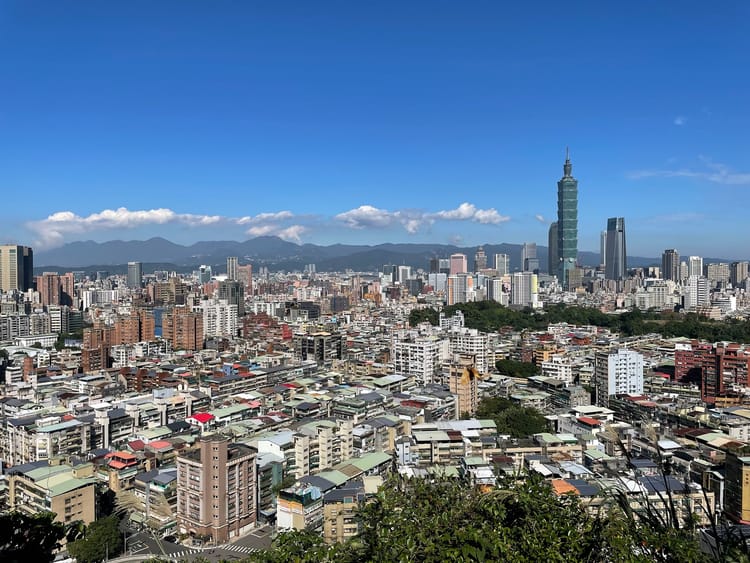 A photo of the Taipei skyline, with Taipei 101 in the distance.